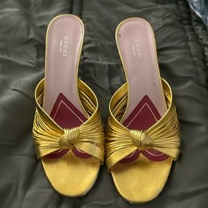 GUCCI Metallic Nappa Crawford Knotted Mid Heel Slides Gold 3-inch kitten heel.